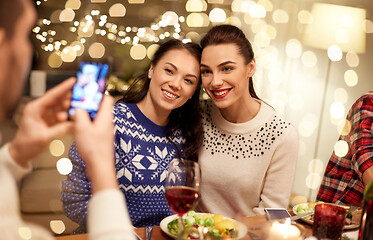 Image showing friends having christmas dinner and taking picture