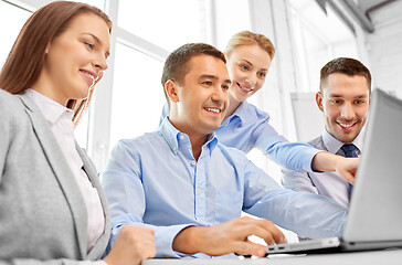 Image showing happy business team with laptop computer in office