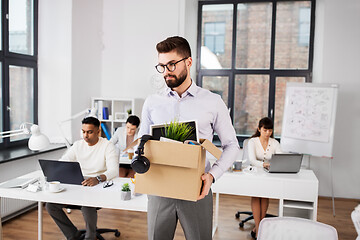 Image showing sad fired male office worker with personal stuff