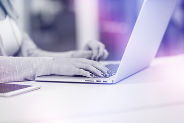 Image showing businesswoman using a laptop in startup office