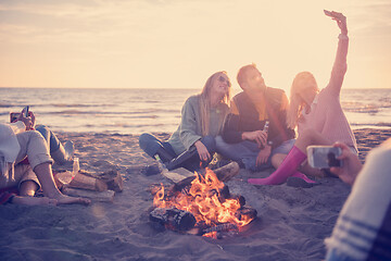 Image showing Friends having fun at beach on autumn day