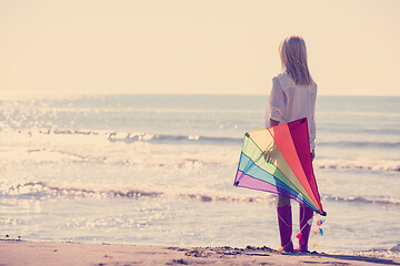 Image showing Young Woman with kite at beach on autumn day