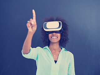 Image showing black girl using VR headset isolated on gray background