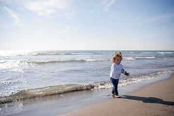 Image showing cute little girl at autumn beach