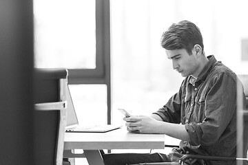 Image showing Young casual businessman using smartphone