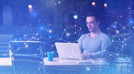 Image showing man working on laptop in dark office