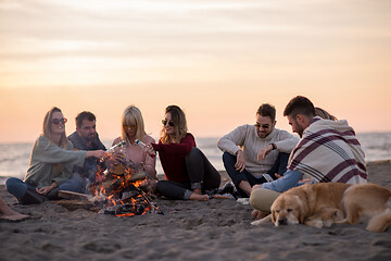 Image showing Friends having fun at beach on autumn day