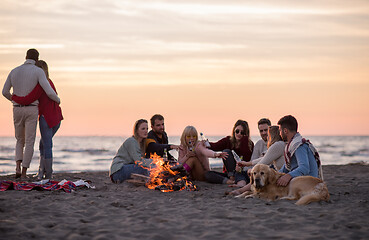 Image showing Couple enjoying with friends at sunset on the beach