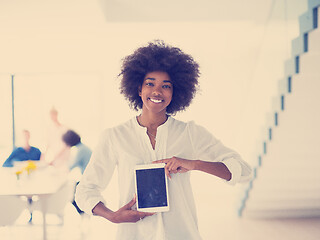 Image showing Portrait of  black casual businesswoman using tablet  with cowor