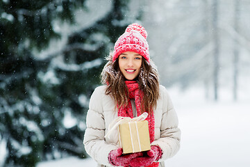 Image showing happy young woman with christmas gift in winter