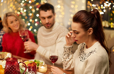 Image showing woman calling on smartphone at christmas dinner