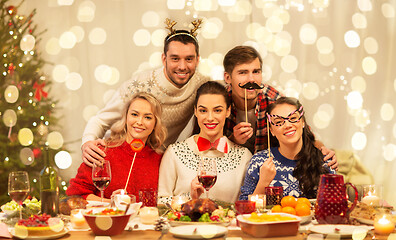 Image showing happy friends celebrating christmas at home