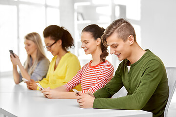 Image showing happy high school students with smartphones