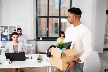 Image showing sad fired male office worker with personal stuff