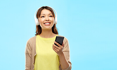 Image showing asian woman in headphones listening to music