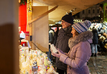 Image showing happy senior couple hugging at christmas market