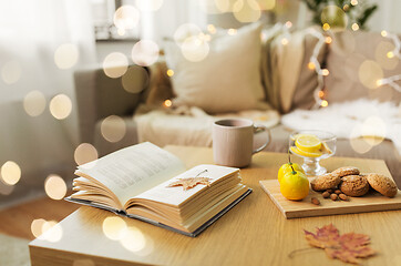 Image showing book, lemon, tea and cookies on table at home