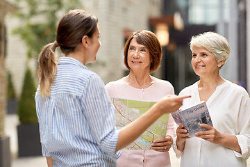 Image showing passerby showing direction to senior women in city