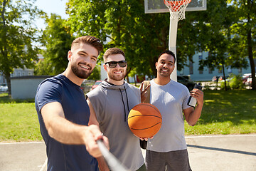 Image showing happy men taking selfie on basketball playground