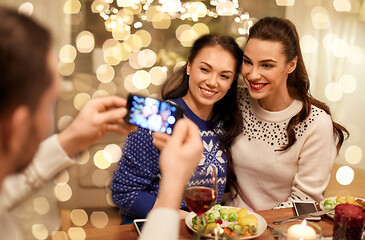 Image showing friends having christmas dinner and taking picture