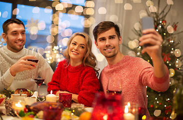 Image showing friends taking selfie at christmas dinner