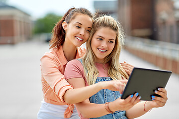 Image showing teenage girls with tablet computer on roof top