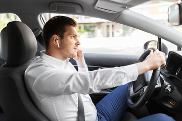 Image showing man or driver with wireless earphones driving car