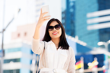 Image showing asian woman taking selfie by smartphone in city