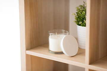 Image showing fragrance candle in glass holder on shelving