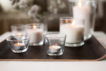 Image showing burning fragrance candles on table at cozy home