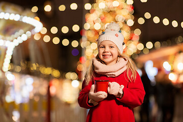 Image showing happy girl with cup of tea at christmas market