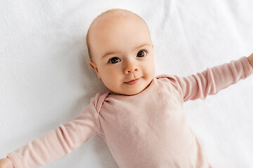 Image showing sweet baby girl lying on white blanket