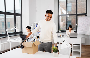 Image showing happy male office worker with personal stuff