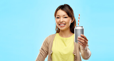 Image showing happy asian woman holding can drink with straw