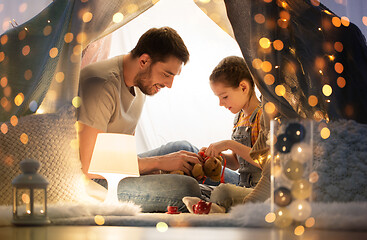 Image showing happy family playing with toy in kids tent at home