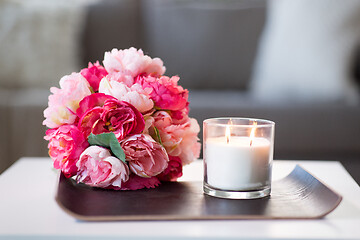 Image showing burning fragrance candle and flower bunch at home