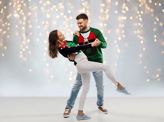 Image showing couple dancing at christmas ugly sweater party