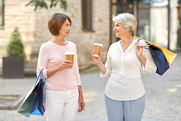 Image showing senior women with shopping bags and coffee in city