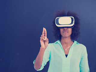 Image showing black girl using VR headset isolated on gray background