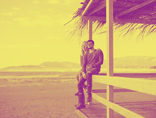 Image showing young couple drinking beer together at the beach