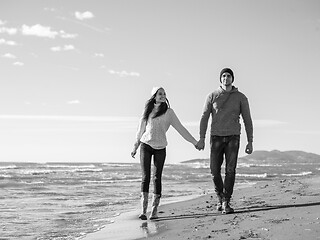 Image showing Loving young couple on a beach at autumn sunny day