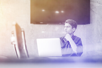 Image showing businessman working using a laptop in startup office