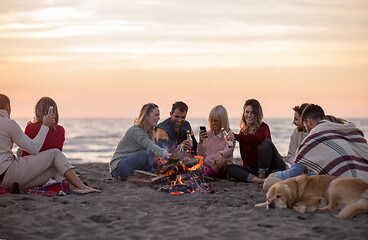 Image showing Friends having fun at beach on autumn day