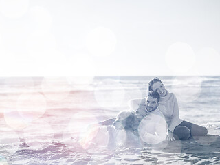 Image showing Couple with dog enjoying time on beach