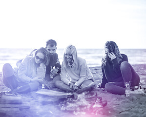 Image showing Friends having fun at beach on autumn day