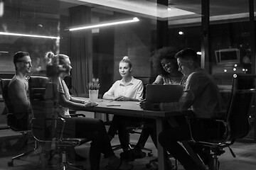 Image showing Multiethnic startup business team in night office