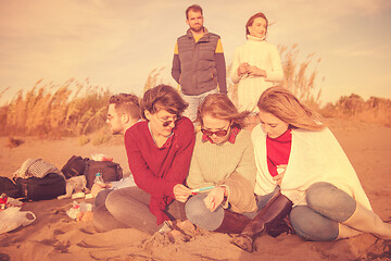 Image showing Friends having fun at beach on autumn day