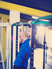 Image showing man doing pull ups on the horizontal bar