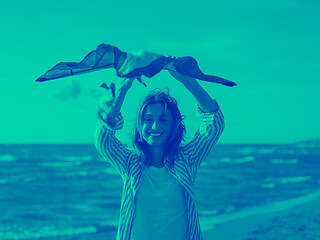 Image showing Young Woman holding kite at beach on autumn day