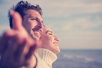 Image showing Loving young couple on a beach at autumn sunny day